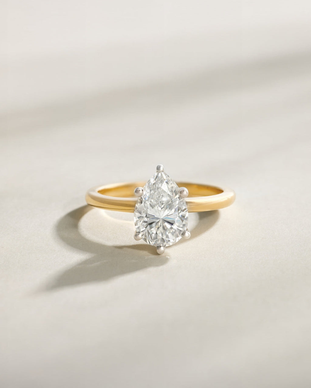 Pear solitaire engagement ring setting in 14K yellow gold shown with a 3.00 ct pear centre diamond