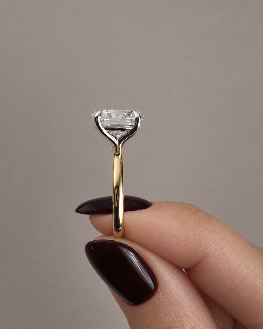 Four prong solitaire engagement ring with sculpted gold setting, shown with round centre diamond side view