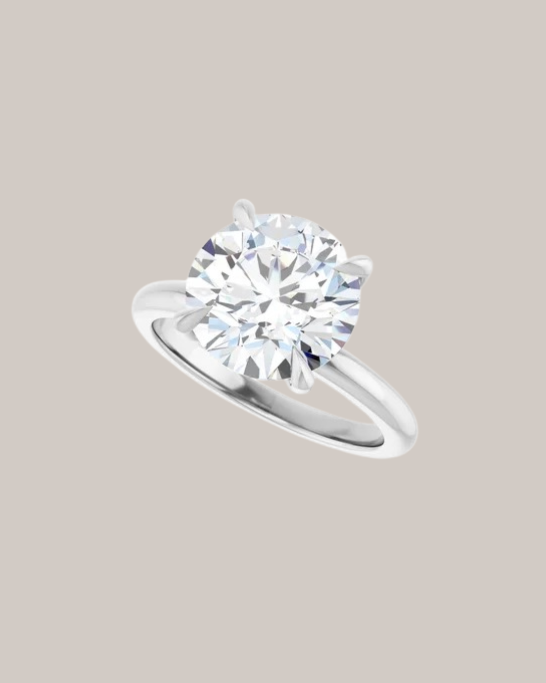 Four prong solitaire engagement ring with sculpted gold setting, shown with round centre diamond