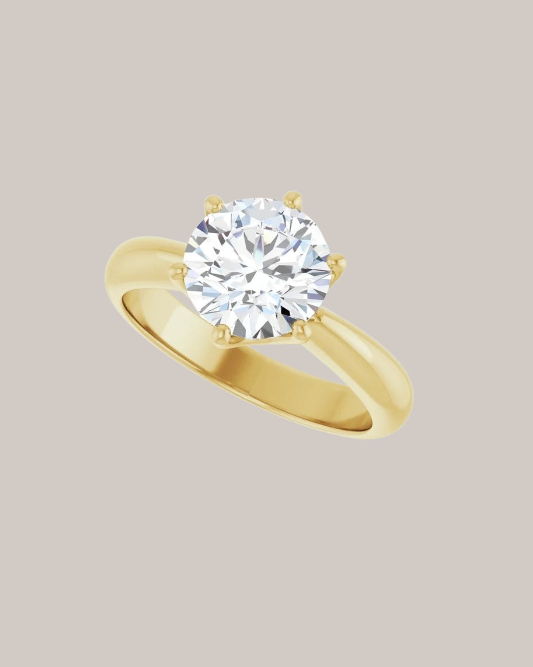Classic solitaire engagement ring with substantial polished yellow gold band