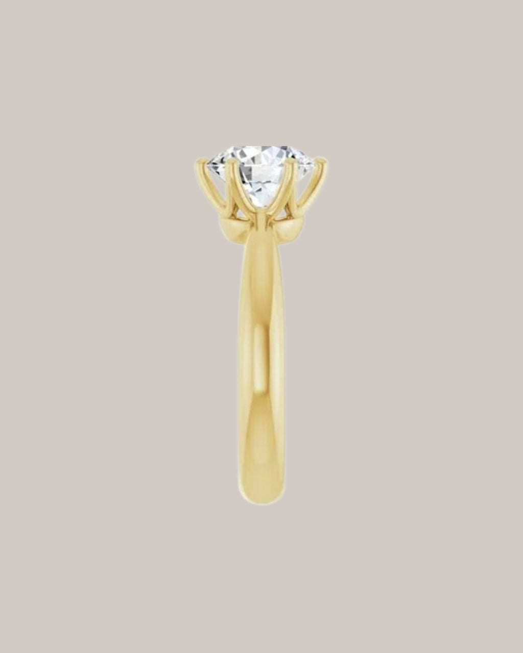 Classic solitaire engagement ring with substantial polished yellow gold band side view