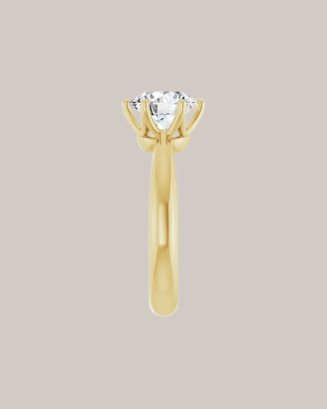 Classic solitaire engagement ring with substantial polished yellow gold band side view