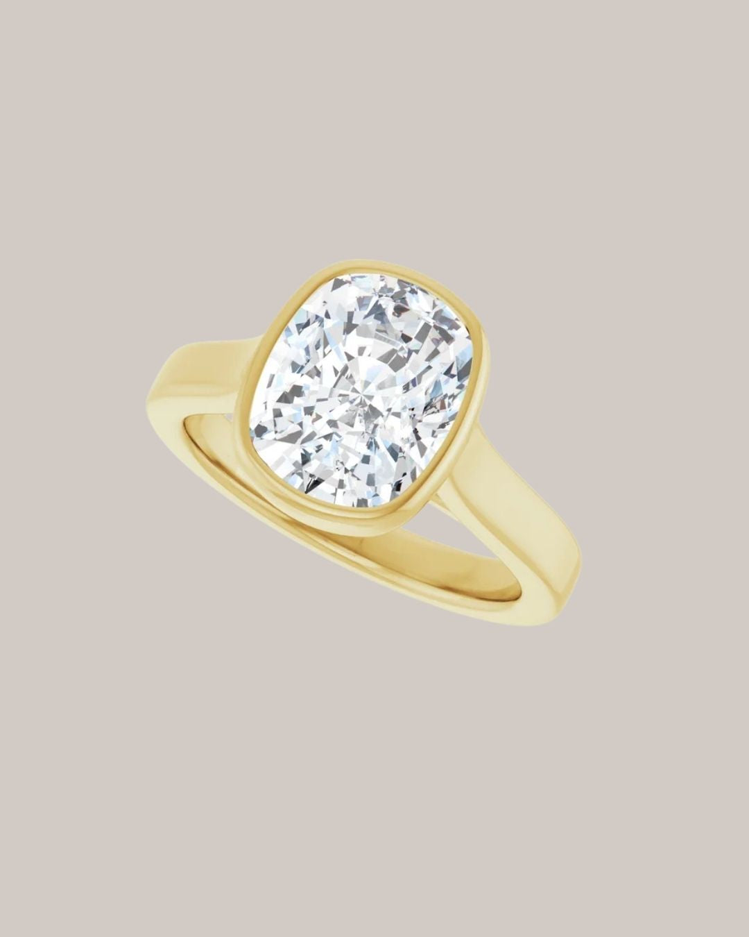 14K yellow gold bezel engagement ring shown with a 3.50 ct elongated cushion centre diamond
