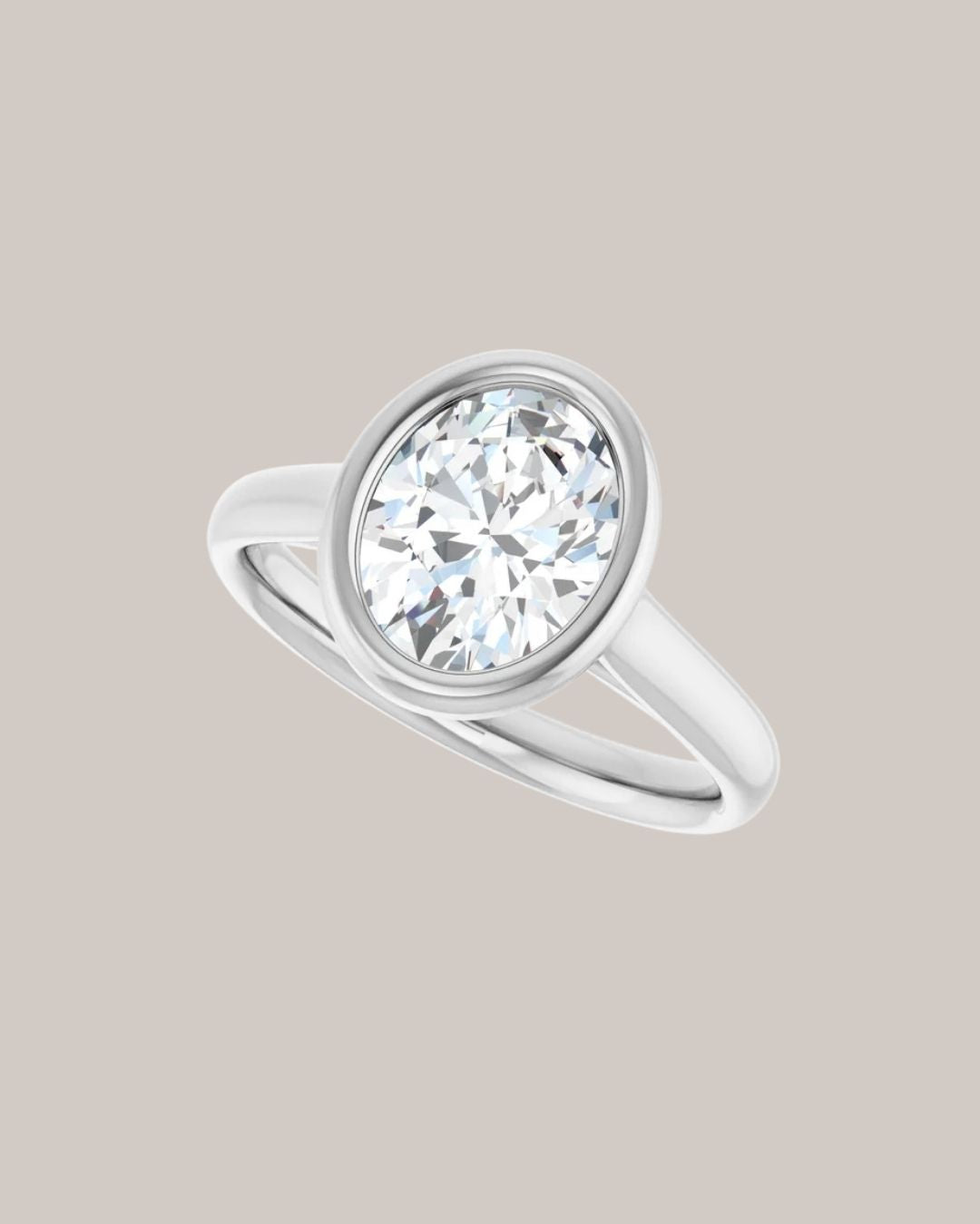 14K white gold bezel engagement ring shown with a 2.00 ct oval centre diamond