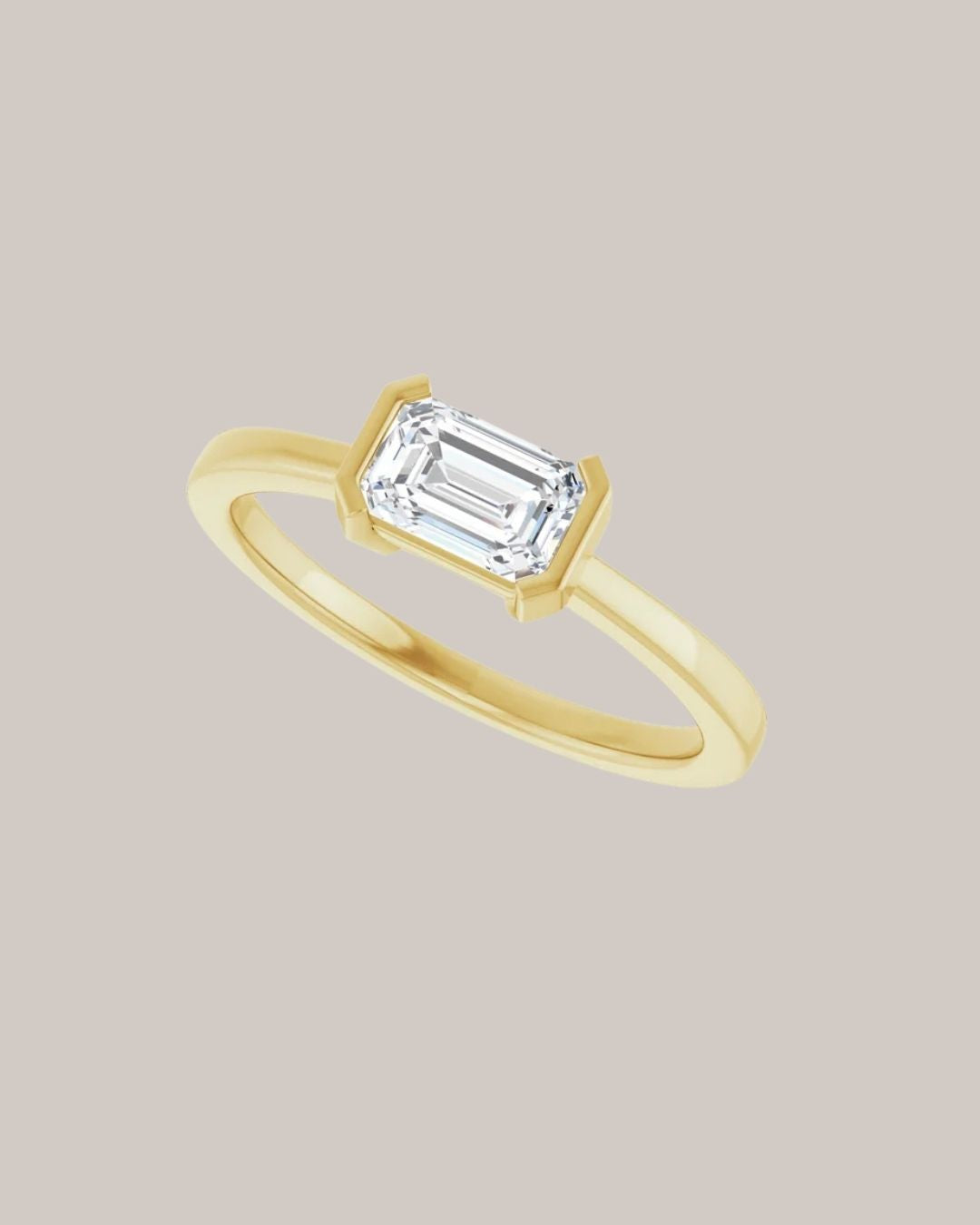 Emerald East West Solitaire Ring
