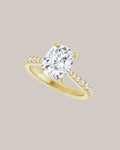 Elongated cushion engagement ring with lab grown diamond accents in yellow gold