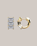 Lab grown emerald cut diamond huggie earrings with three diamonds per hoop in 14K yellow gold