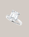14K white gold solitaire engagement ring shown with a 4.00 ct emerald cut centre diamond
