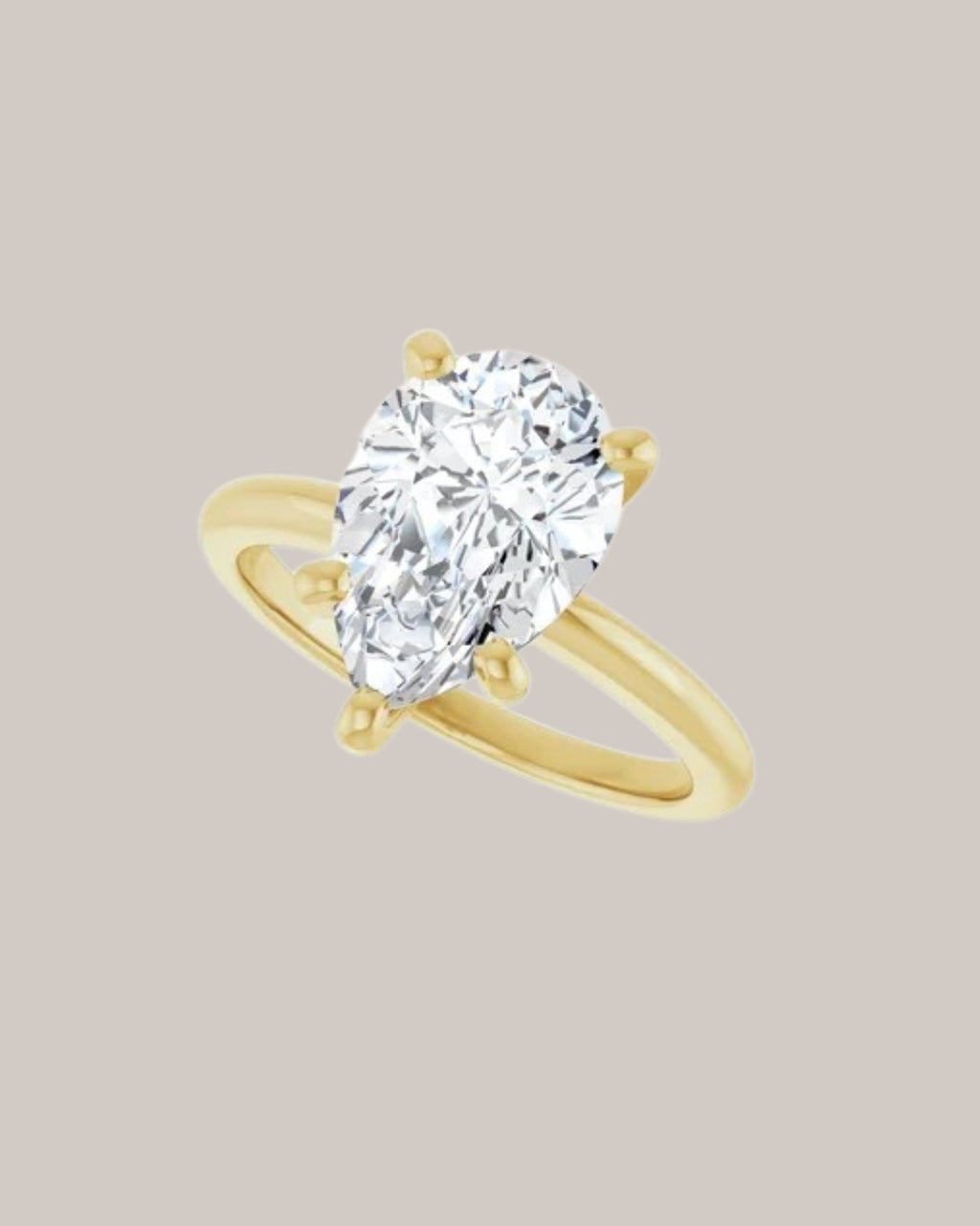Pear solitaire engagement ring setting in 14K yellow gold shown with a 3.00 ct pear centre diamond