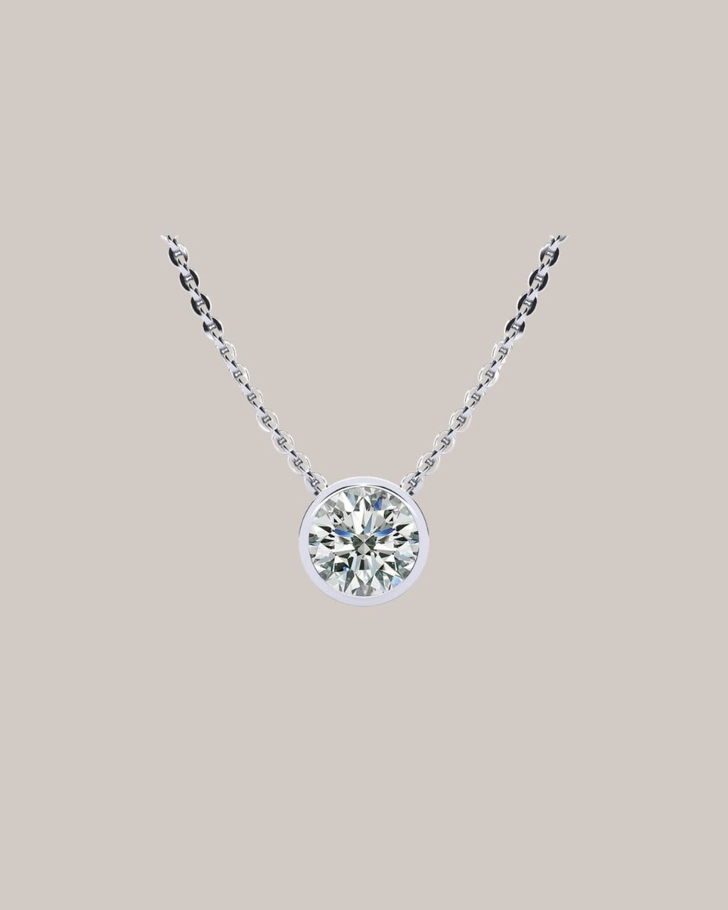 White gold 1.50 ct bezel set round diamond pendant on an 18 inch cable chain
