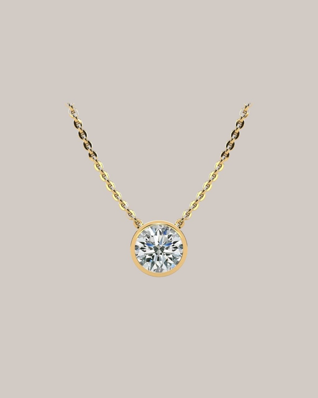 Yellow gold 1.50 ct bezel set round diamond pendant on an 18 inch cable chain
