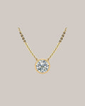 Yellow gold 1.50 ct bezel set round diamond pendant on an 18 inch cable chain
