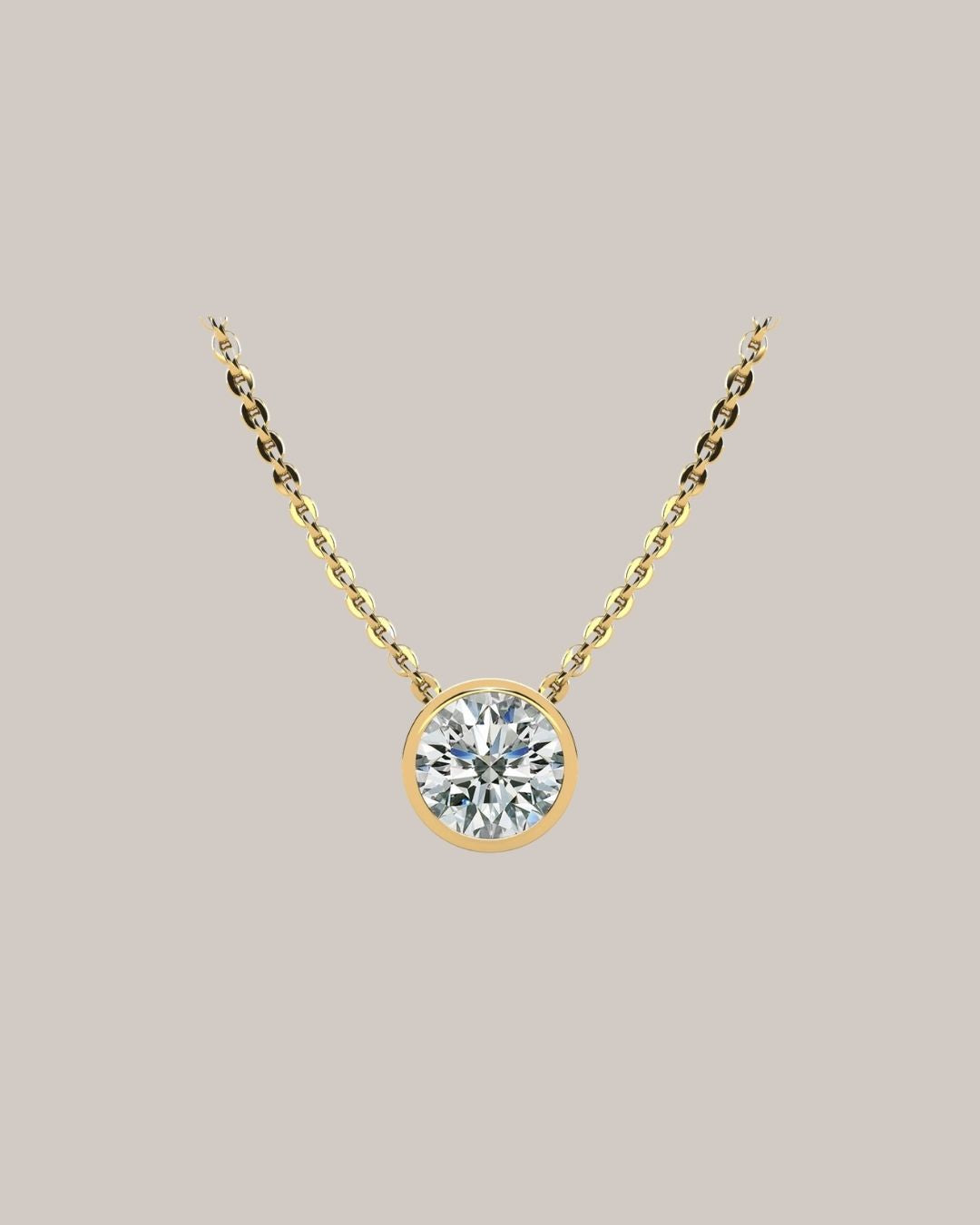 Yellow gold 1.50 ct bezel set round diamond pendant on an 18 inch cable chain
