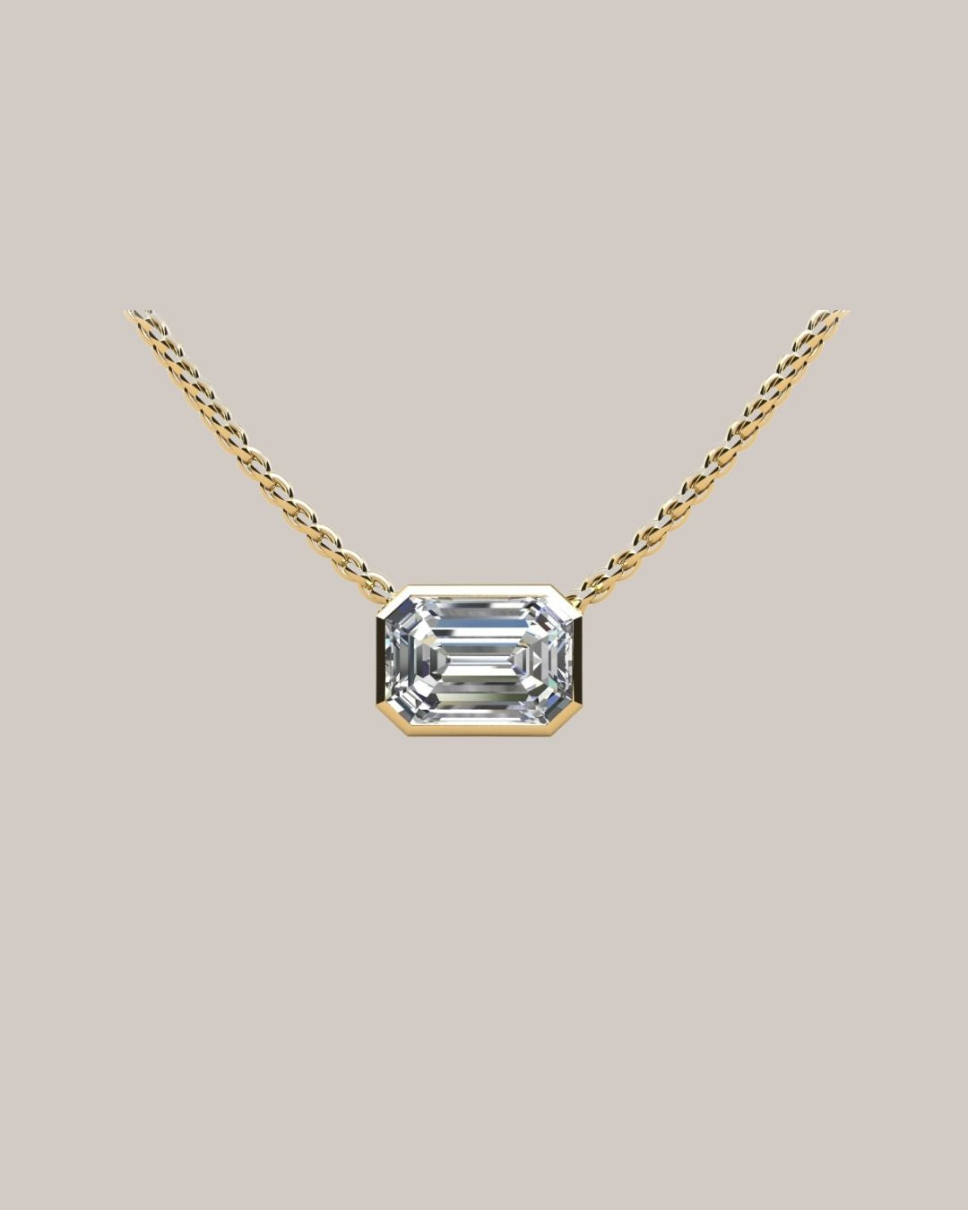 Yellow gold 1.00 ct emerald cut diamond solitaire pendant on an 18 inch cable chain
