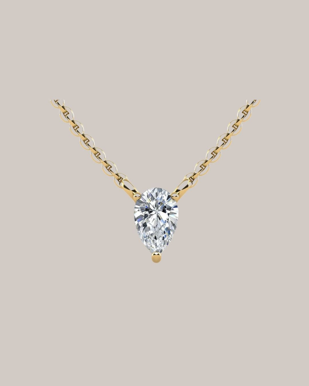 Yellow gold 1.00 ct pear shaped diamond solitaire pendant on an 18 inch cable chain