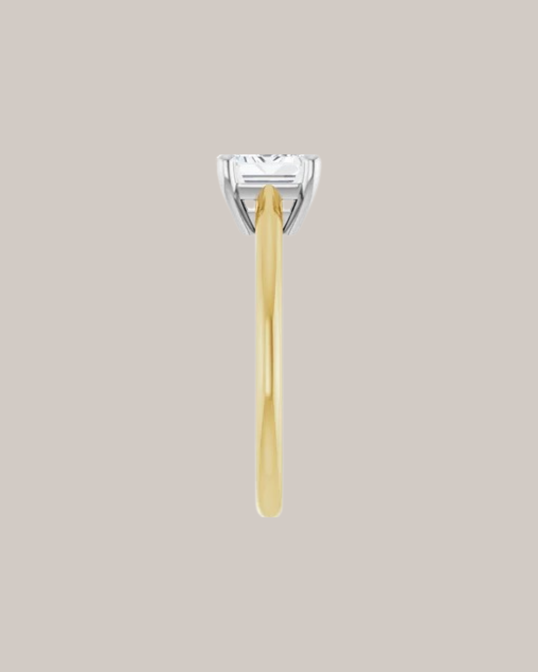 Two tone east west emerald cut solitaire engagement ring in 14K gold shown with a 1.75 ct centre diamond