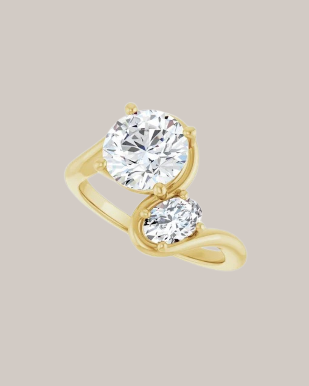 Round and oval two stone diamond ring in 14K gold with 2.00 ct round centre and 0.50 ct oval accent diamond