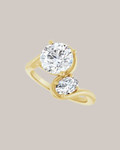 Round and oval two stone diamond ring in 14K gold with 2.00 ct round centre and 0.50 ct oval accent diamond
