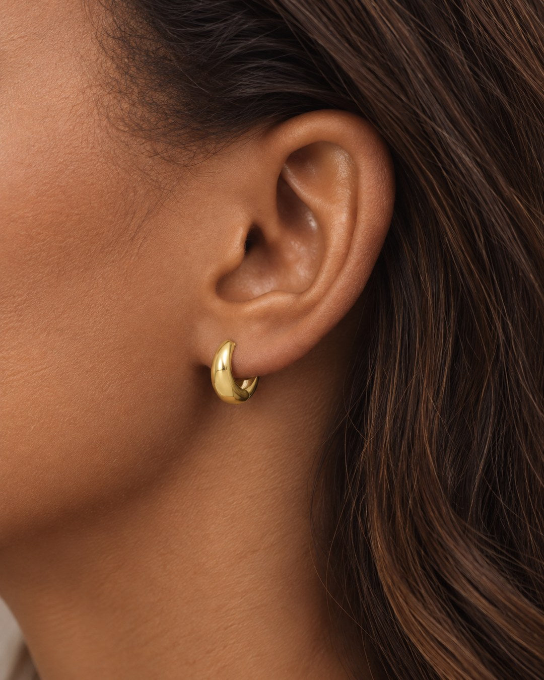 13.5 mm polished 10K yellow gold hoop earrings on ear
