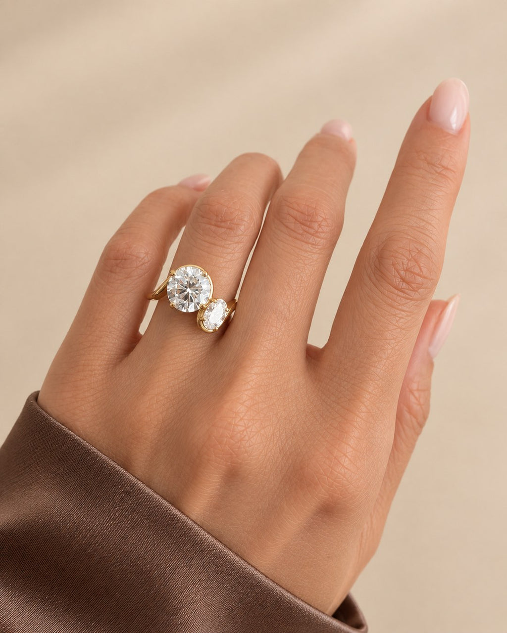 Round and oval two stone diamond ring in 14K gold with 2.00 ct round centre and 0.50 ct oval accent diamond
