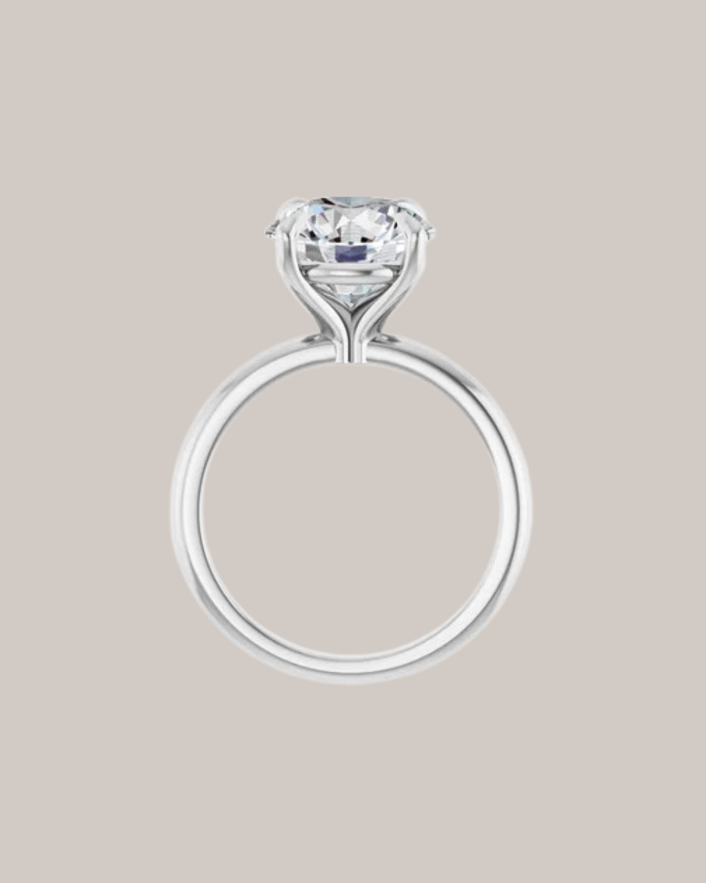 Four prong solitaire engagement ring with sculpted gold setting, shown with round centre diamond side view