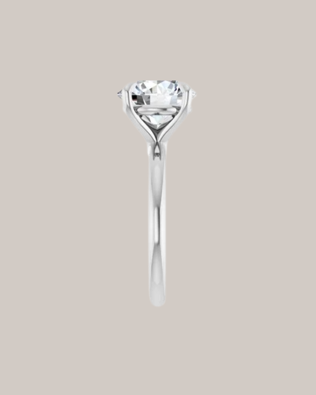 Four prong solitaire engagement ring with sculpted gold setting, shown with round centre diamond side view