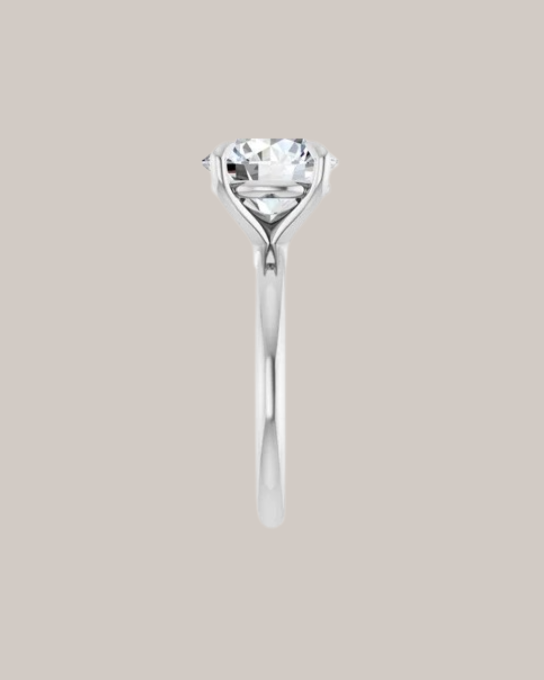 Four prong solitaire engagement ring with sculpted gold setting, shown with round centre diamond side view